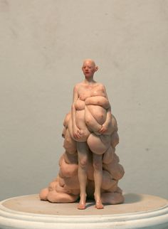 a sculpture of a man holding something in his arms