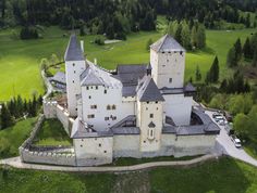 an aerial view of a castle surrounded by trees