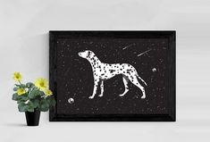 a black and white dalmatian print on a wall next to a potted plant