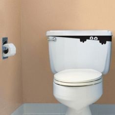 a white toilet sitting in a bathroom next to a roll of toilet paper and a trash can