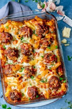 a casserole dish filled with meatballs and cheese