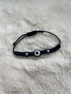 Beautiful Handmade Braided Evil Eye Bracelet in Black with Evil Eye. Use For Protection & Good Luck! Cheap Handmade Black Evil Eye Bracelet, Evil Eye Bracelet Braided, Adjustable Black Round Bracelets, Black Adjustable Bracelets, Casual Black Friendship Bracelet With Black Beads, Adjustable Black Friendship Bracelet, Black Adjustable Braided Bracelet With Sliding Knot, Casual Handmade Black Friendship Bracelets, Black Evil Eye Bracelet With Sliding Knot As Gift