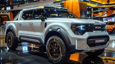 a white truck is on display at an auto show