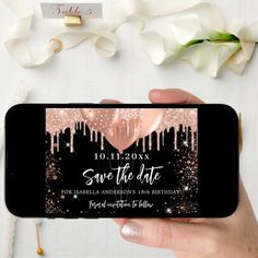 a person holding up a phone with the save the date sticker on it