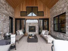 a living room filled with lots of furniture next to a fire place in a building