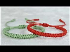 two red and green bracelets sitting next to each other