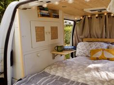 a bed in the back of a camper van