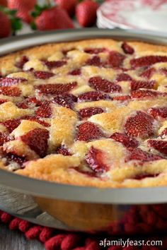 a pie with strawberries in it sitting on a table