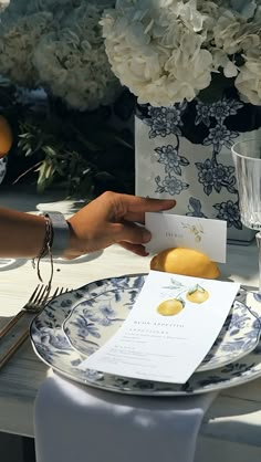 a table set with plates, silverware and flowers