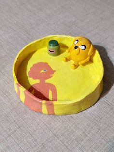 a yellow bowl with an octopus in it