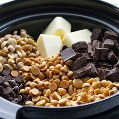 chocolate, butter and peanuts are in the slow cooker to make this healthy snack