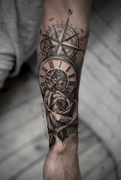 a man's arm with a rose and compass tattoo on it