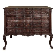 an old wooden dresser with many drawers and carvings on the front, along with a marble top