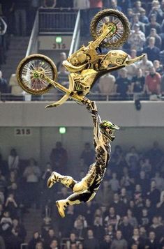 a person on a motorcycle doing tricks in the air