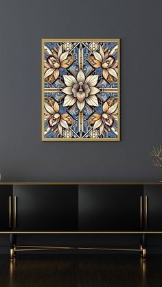 a painting hanging on the wall above a black cabinet in a room with dark walls