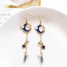 Boho Blue And Gold Crystal Star And Moon Dangle Earrings These Beautiful Earrings Have A Blue Half Moon At The Top With A Little Cloud, Tiny Gold Stars With Crystals, And Dangling Down Are Blue Beads, Faux Pearls, And Blue Stars. A Great Gift For A Friend Who Loves To Star Gaze! Measurements In The Last Picture Zinc Alloy, Crystals, Enamel, Beads Comes With A Sheer Organza Gift Bag Bohemian, Fairy, Whimsical, Romantic, Hippie, Gypsy, Celestial, Bff Gift, Celebration, Birthday, Anniversary, Stock Star And Moon Earrings, Star Gaze, Purple Heart Earrings, Bohemian Fairy, Fairy Whimsical, Whimsical Romantic, Moon Drop, Bff Gift, Boho Blue