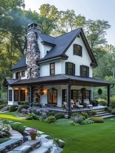 a large white house with lots of windows on it's roof and front porch