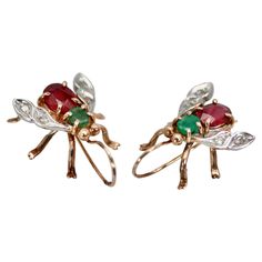 These 14K Yellow Gold fly earrings are stunning and large. The body and ear wires are 14K Yellow Gold, Diamond studded wings with 2 Diamonds on each wing to total 8 Diamonds. Body set with 1 oval Ruby of approximately 1 carat each and 1 oval Emerald of 1/2 a carat to total 1 carat. Weight is 7.4 grams and size is 2.5cm x 1.78 cm. I purchased these from an Italian Auction House which I do a lot of business with. These stones have not been tested so I do not know if they are real or synthetic but Insect Earrings, Fly Earrings, 1 Carat, Diamond Studs, Ear Wires, Gold Diamond, Emerald, Fine Jewelry, Jewelry Earrings