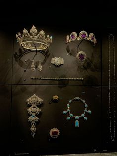 several tiaras and necklaces on display in a museum