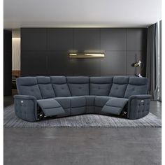 a grey couch sitting on top of a rug in a living room