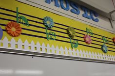 music themed bulletin board with paper flowers on it