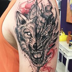 a woman with a wolf tattoo on her arm