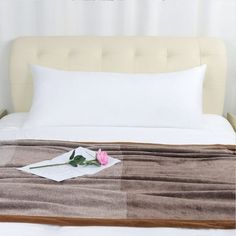 a bed with a flower on top of it