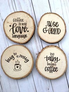 four wooden coasters with coffee quotes on them