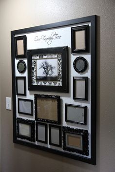 a black and white photo frame with many different frames hanging on it's wall