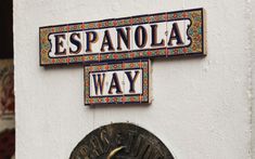 two signs on the side of a building that say espanola way and spanish