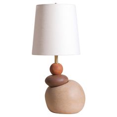 a lamp that is sitting on top of a rock with two rocks stacked on it