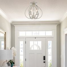 a white front door with two sidelights and a lamp