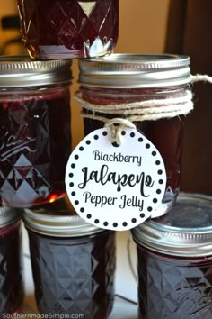 jars filled with jam sitting on top of a table