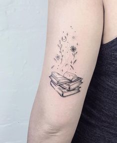 a woman's arm with a book tattoo on the left side of her arm