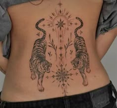 a woman's back with two tigers on it