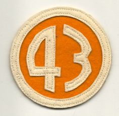 an orange and white patch with the number four in it's center on a white background