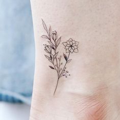 a small flower tattoo on the ankle