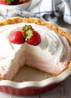 a strawberry cream pie with one slice cut out