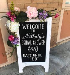 a welcome sign for the bride and groom to arrive at their wedding ceremony in front of a brick building