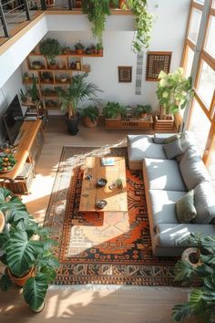 a living room filled with furniture and lots of plants