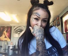 a woman with tattoos covering her mouth