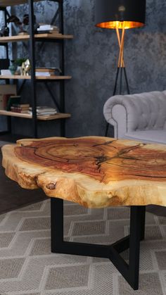 a living room with a table made out of wood and metal legs on carpeted flooring