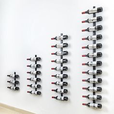 several wine bottles are lined up on the wall