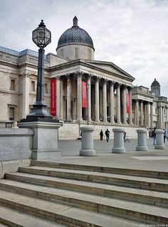 the steps lead up to an old building with columns and pillars in front of it