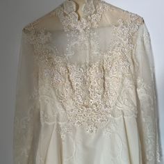 Wedding Dress From 60s Or 70s. Never Worn. Dress Says Size 8. Unknown If It Is True To Size. Non Smoking And Bug Free Home. We Do Have Dogs But They Have Not Been Near The Dress. Beautiful Bead Work And Small Train. 70 Wedding Dress Vintage 70s, 1970s Style Fitted Vintage Dress For Vintage Events, Retro Long Sleeve Dresses For Vintage Events, 1970s Style Wedding Dress, Classic A-line Vintage Wedding Dress, Retro Lace Wedding Dress, Vintage Long Sleeve Dress With Fitted Bodice, 1970s Vintage Wedding Dress, White Vintage Dress For Evening