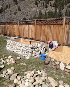 a man is building a wall out of rocks