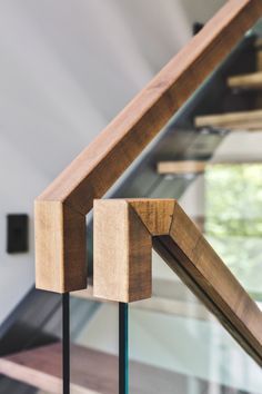 a close up of a wooden frame on a glass railing