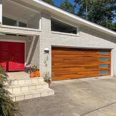 a house with two red garage doors in front of it