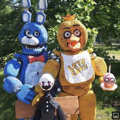 three stuffed animals standing next to each other