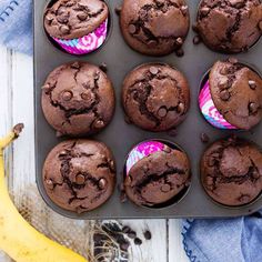 chocolate muffins in a pan with bananas on the side